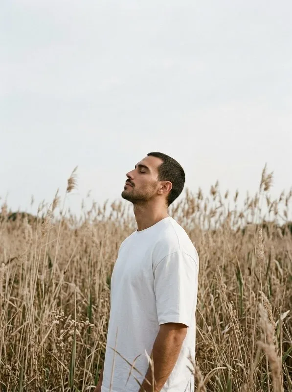 Create a premium double-exposure portrait of the uploaded man. The composition should match the reference image