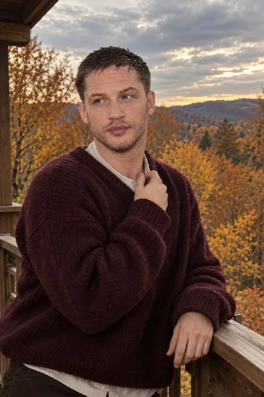 Ultra-realistic autumn portrait of an androgynous person on a wooden balcony surrounded by golden fall trees.