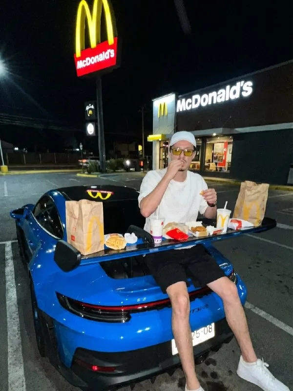 Captured on a smartphone with a harsh direct flash late at night: A man in high-end