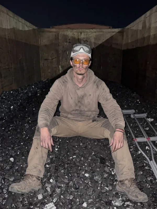 A raw, handheld smartphone picture, taken at night inside a freight train car open to the