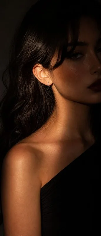 A hyper-realistic 9:21 aspect ratio 8K close-up portrait of a girl with flawless bronze-tanned skin. The